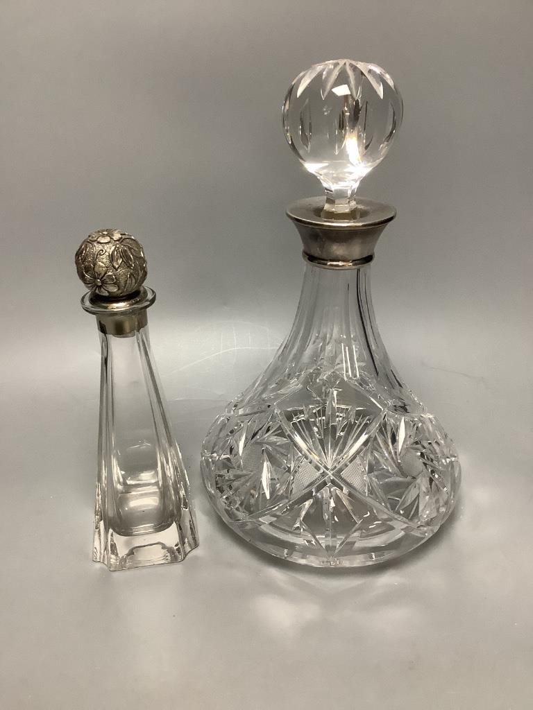 A silver collared cut glass decanter and a glass scent bottle with 800 standard silver stopper, tallest 27cm and a set of 5 etched wine glasses.